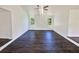 Living room featuring new flooring, ceiling fan, and natural light from multiple windows at 294 Farm Ridge Ne Dr, Woodstock, GA 30188