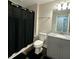 Bathroom featuring dark-colored shower curtain and gray vanity at 3407 Hidden Stream Ct, Stockbridge, GA 30281