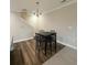 Bright dining area featuring wood-look flooring and modern chandelier at 3407 Hidden Stream Ct, Stockbridge, GA 30281