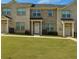 Well-maintained townhomes with a brick facade and manicured lawn at 3407 Hidden Stream Ct, Stockbridge, GA 30281