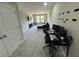 Spacious living room featuring a large window and modern desk at 3407 Hidden Stream Ct, Stockbridge, GA 30281