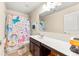 Cheerful bathroom showcasing a colorful unicorn shower curtain and a single sink vanity at 517 Dasheill Ln, Atlanta, GA 30349
