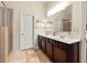 Main bathroom featuring double sink vanity, walk in shower, and neutral paint at 517 Dasheill Ln, Atlanta, GA 30349