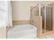Main bathroom featuring a tub, shower, and window at 517 Dasheill Ln, Atlanta, GA 30349