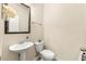 Half bathroom features a pedestal sink, toilet, and neutral paint at 517 Dasheill Ln, Atlanta, GA 30349