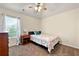 Cozy bedroom with a ceiling fan and a comfortable bed by a bright window at 517 Dasheill Ln, Atlanta, GA 30349