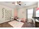 Bedroom features a ceiling fan, curtains, and carpet at 517 Dasheill Ln, Atlanta, GA 30349