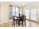 Bright breakfast area with a modern table set, natural lighting, and access to the kitchen at 517 Dasheill Ln, Atlanta, GA 30349
