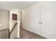 Upstairs hallway with carpet flooring and white doors to bedrooms at 517 Dasheill Ln, Atlanta, GA 30349