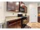 Well-equipped kitchen showcasing granite counters, dark cabinets, and modern appliances at 517 Dasheill Ln, Atlanta, GA 30349