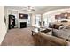 Comfortable living room with a fireplace, large TV, and seamless flow into the dining area and kitchen at 517 Dasheill Ln, Atlanta, GA 30349