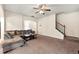 Relaxing living room showcasing a staircase, large sofa, carpeted floors, and neutral walls at 517 Dasheill Ln, Atlanta, GA 30349