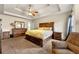 Spacious main bedroom with tray ceiling and matching furniture at 517 Dasheill Ln, Atlanta, GA 30349