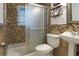 Bathroom featuring frosted shower doors, modern toilet, and pedestal sink at 1083 Grace Dr, Forest Park, GA 30297