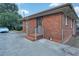Rear exterior view shows brick siding, painted trim, and fenced backyard at 1083 Grace Dr, Forest Park, GA 30297