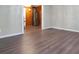 Spacious living room with hardwood floors and modern wall accents, leading to an adjacent kitchen at 1083 Grace Dr, Forest Park, GA 30297