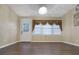 Bright living room with hardwood floors, a modern chandelier, and natural light from large windows at 1083 Grace Dr, Forest Park, GA 30297