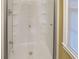 Contemporary shower featuring glass doors, multiple shower heads, and built-in shelving for storage at 1083 Grace Dr, Forest Park, GA 30297