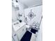 Well-lit bathroom with modern vanity, framed mirror, and nautical themed shower curtain at 1298 Gideons Sw Dr, Atlanta, GA 30314