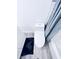 Toilet with a dark rug, next to a bathtub with grey curtain at 1298 Gideons Sw Dr, Atlanta, GA 30314