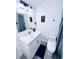 A well-lit bathroom featuring a vanity with solid surface top, toilet, shower with curtain, and tiled floor at 1298 Gideons Sw Dr, Atlanta, GA 30314