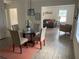 Inviting dining room with a glass table, seating for four, and an open view to the adjacent living room at 1298 Gideons Sw Dr, Atlanta, GA 30314