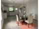 Inviting dining area with a glass table, four chairs, and an adjacent open kitchen at 1298 Gideons Sw Dr, Atlanta, GA 30314