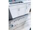 Kitchen cabinets under the sink with a light blue floral rug on the floor at 1298 Gideons Sw Dr, Atlanta, GA 30314