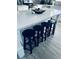 Kitchen island featuring a white countertop and four black stools at 1298 Gideons Sw Dr, Atlanta, GA 30314