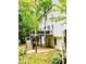 Backyard with stairs leading to a deck, a patio underneath, and a surrounding of natural, lush greenery at 2870 Willow Wisp Way, Cumming, GA 30040