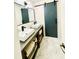 Modern bathroom with dual sinks, stylish fixtures, a sliding barn door, and elegant tile floors at 2870 Willow Wisp Way, Cumming, GA 30040