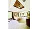 Serene bedroom with wood paneled ceiling, soft carpet, and abundant natural light from multiple windows at 2870 Willow Wisp Way, Cumming, GA 30040