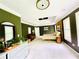 Large bedroom with green-painted walls and soft carpet, offering plenty of natural light at 2870 Willow Wisp Way, Cumming, GA 30040
