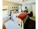 Bright bedroom featuring large bed, windows, ceiling fan, side table and lounge chairs at 2870 Willow Wisp Way, Cumming, GA 30040