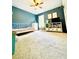 Inviting bedroom with teal walls, large window, and ample natural light, creating a cozy and cheerful space at 2870 Willow Wisp Way, Cumming, GA 30040