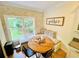 Cozy breakfast nook with a brick accent wall, banquette seating, and a wooden table at 2870 Willow Wisp Way, Cumming, GA 30040