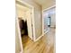 Entryway view of a coat closet and a partial view of a living room featuring wood floors and neutral walls at 2870 Willow Wisp Way, Cumming, GA 30040