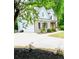 Charming exterior with brick accents, a well-manicured lawn, and a welcoming front porch at 2870 Willow Wisp Way, Cumming, GA 30040