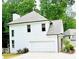 Charming two-story home featuring a two-car garage, a chimney, and beautiful landscaping surrounded by lush greenery at 2870 Willow Wisp Way, Cumming, GA 30040