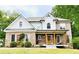 Charming two-story brick home with a welcoming front porch and beautifully landscaped front yard at 2870 Willow Wisp Way, Cumming, GA 30040
