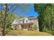 Elegant brick and siding home with a welcoming front porch and lush green landscaping at 2870 Willow Wisp Way, Cumming, GA 30040