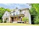 Charming brick and siding home with a welcoming front porch and lush green surroundings at 2870 Willow Wisp Way, Cumming, GA 30040