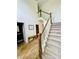 Bright foyer featuring elegant staircase with stained wood handrail and a convenient half bath at 2870 Willow Wisp Way, Cumming, GA 30040