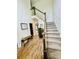 Foyer featuring hardwood floors, staircase with carpet, and a bench seat at 2870 Willow Wisp Way, Cumming, GA 30040