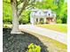 Lovely brick home with a welcoming porch and lush landscaping, set back from a long driveway lined with mulch at 2870 Willow Wisp Way, Cumming, GA 30040