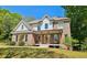 Charming two-story brick home with a welcoming front porch and manicured lawn at 2870 Willow Wisp Way, Cumming, GA 30040