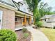 Inviting front porch with swing, wooden columns, brick accents, and landscaped walkway at 2870 Willow Wisp Way, Cumming, GA 30040