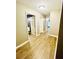 Open hallway with light wood floors and neutral walls, leading to various rooms in the house at 2870 Willow Wisp Way, Cumming, GA 30040