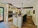 Bright kitchen with center island, granite countertops, stainless steel appliances, and wood-look flooring at 2870 Willow Wisp Way, Cumming, GA 30040