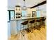 Well-appointed kitchen with a granite island, stainless steel appliances, bar stool seating, and modern pendant lights at 2870 Willow Wisp Way, Cumming, GA 30040